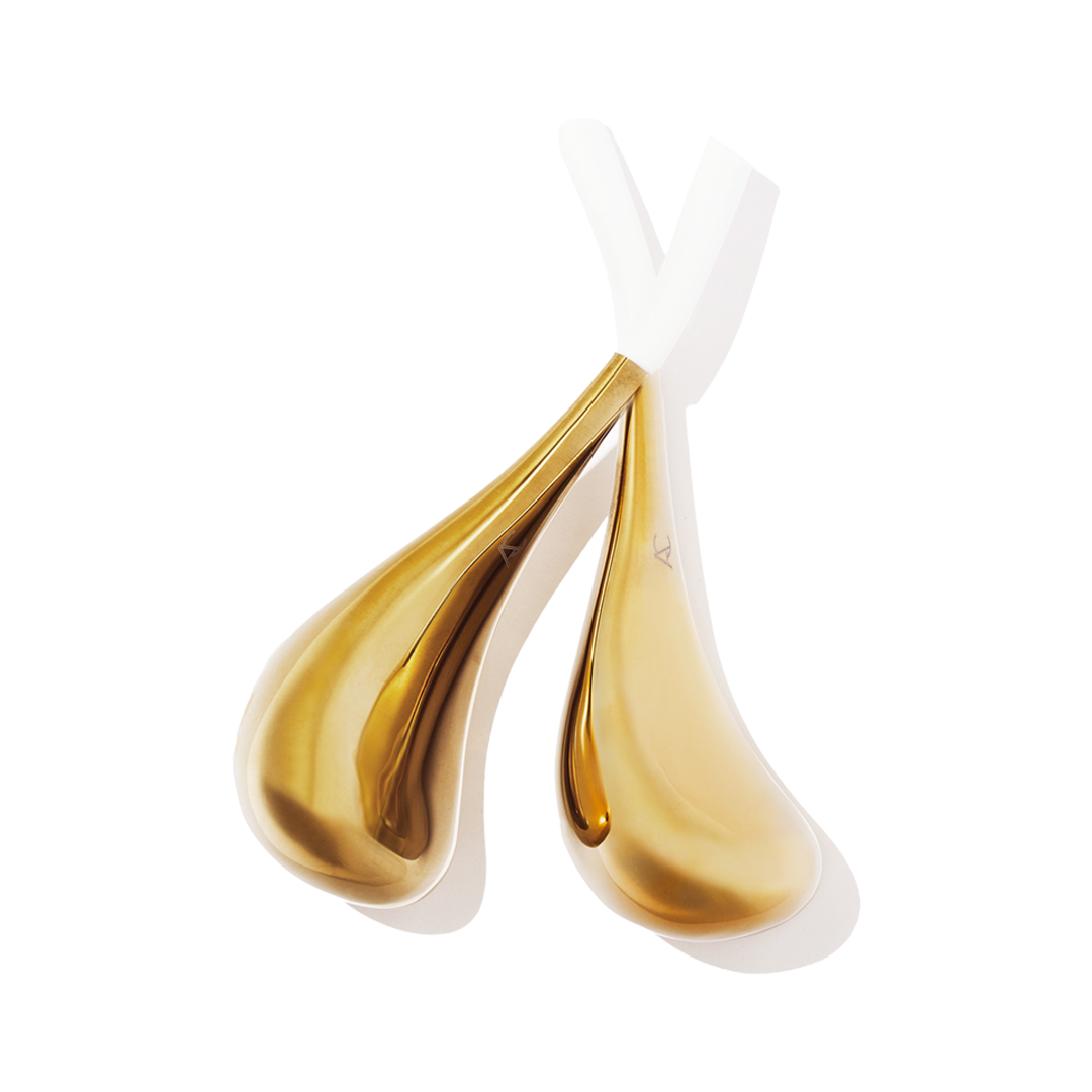 Gold plated spoon-shaped metal tools filled with gel and white silicone handles.