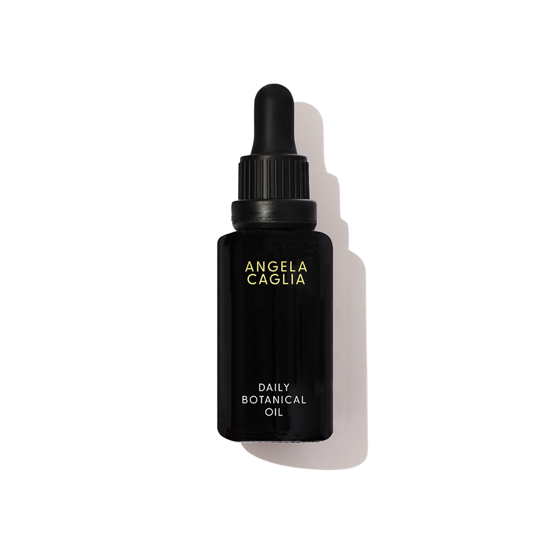 Black oil bottle with black dropper top white background.