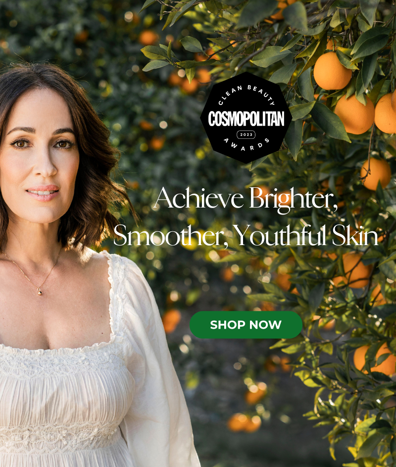 Angela Caglia next to orange tree.